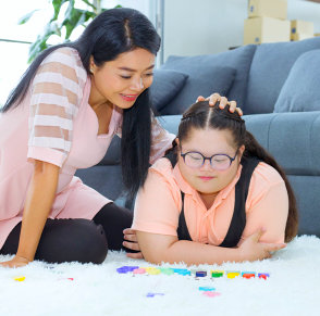 therapist and a mentally disabled girl playing