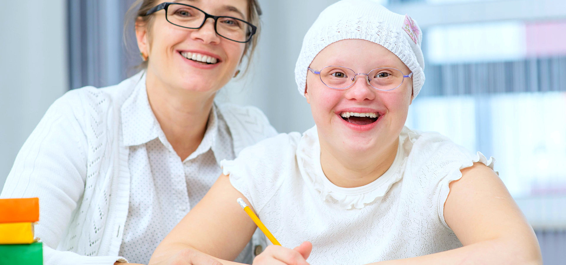 therapist helping a mentally disabled girl write