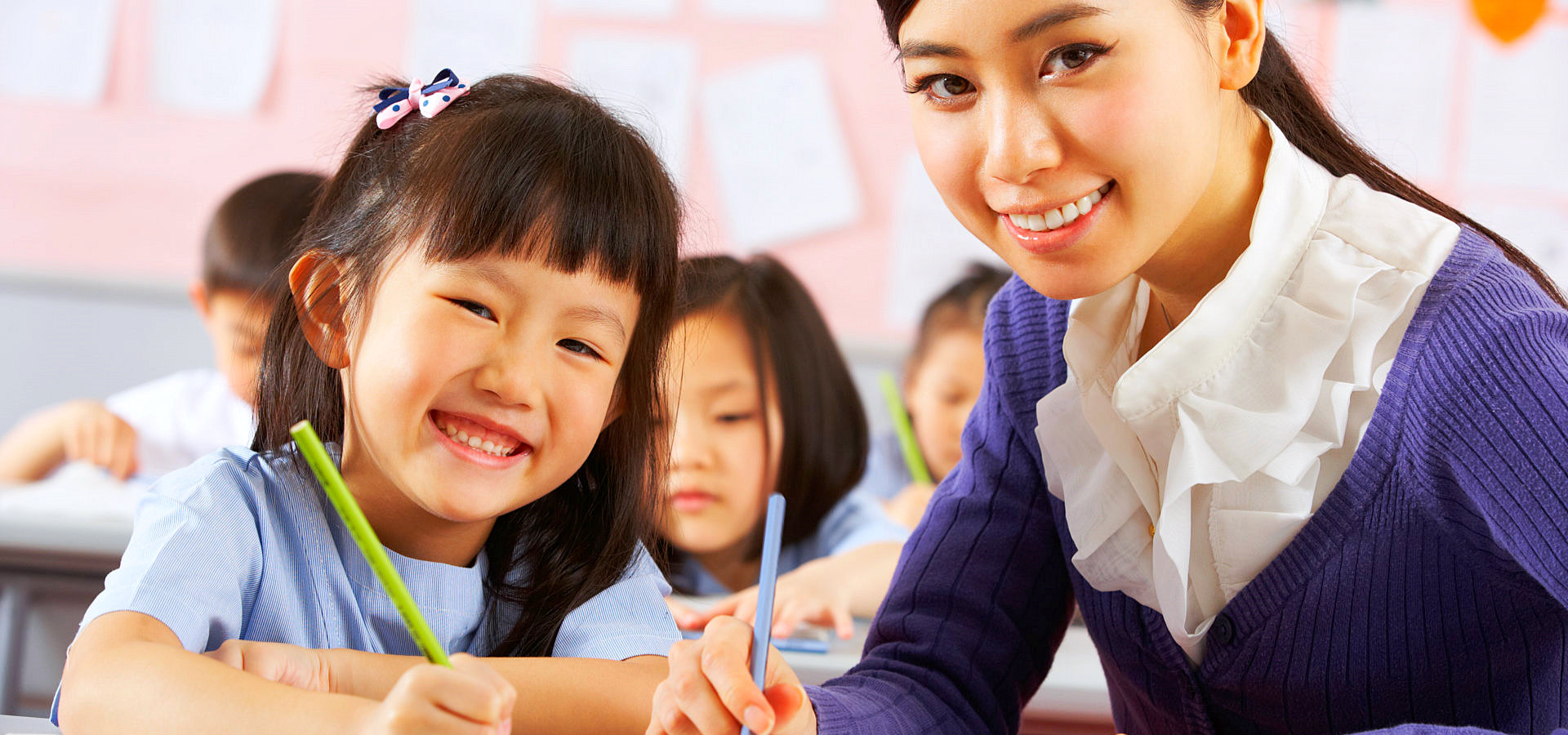 therapist and a little girl smiling at the camera