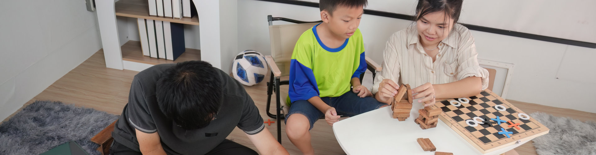 three kids and an adult playing